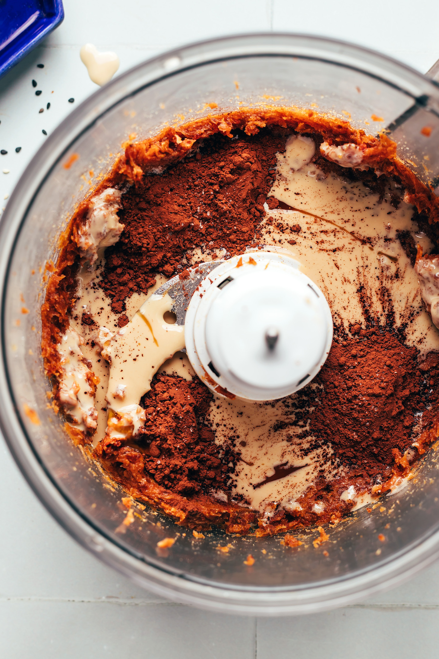 Food processor with tahini, cocoa powder, vanilla, and dates