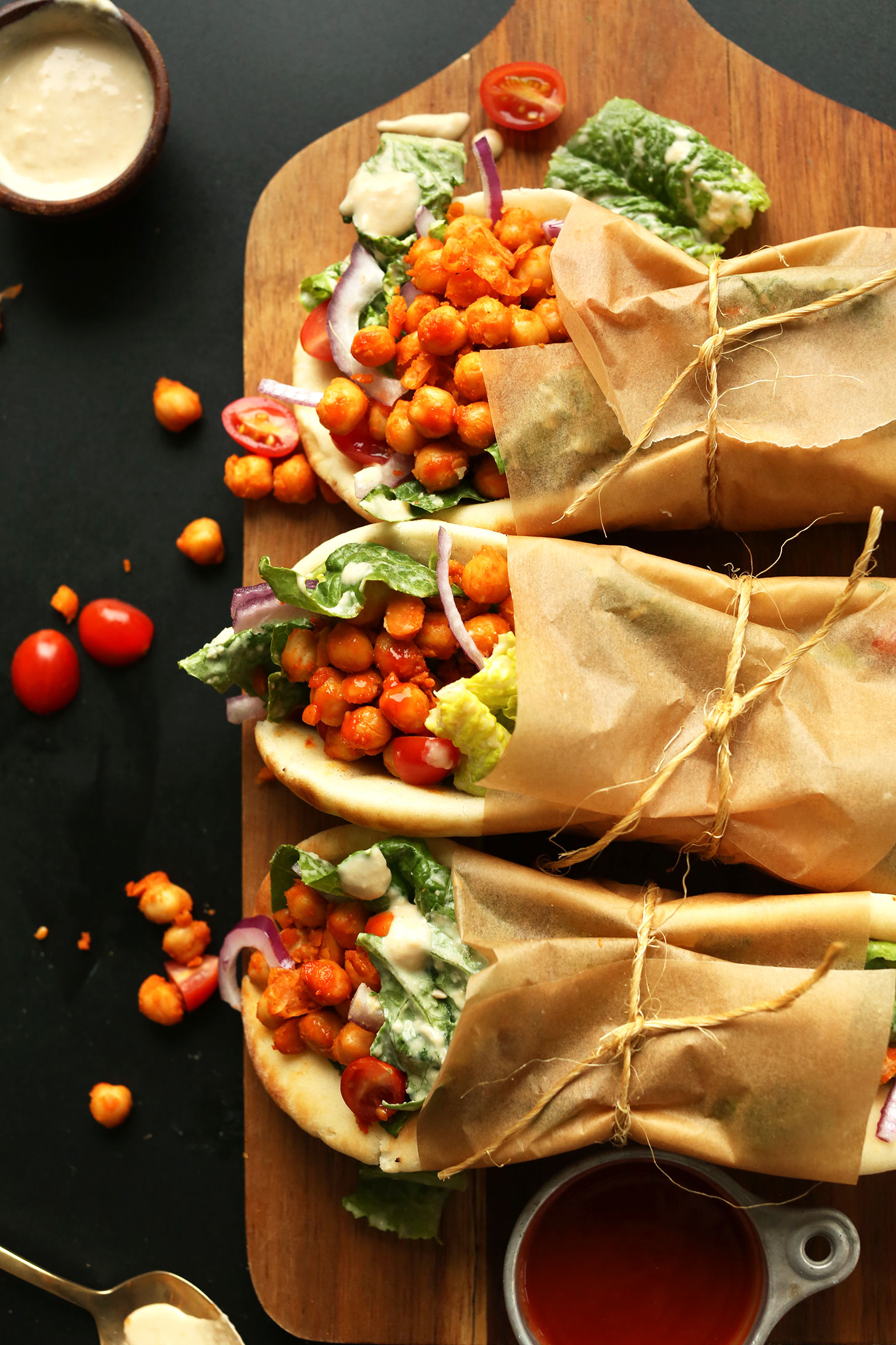 Amazing vegan Buffalo Chickpea Wraps served on pita bread