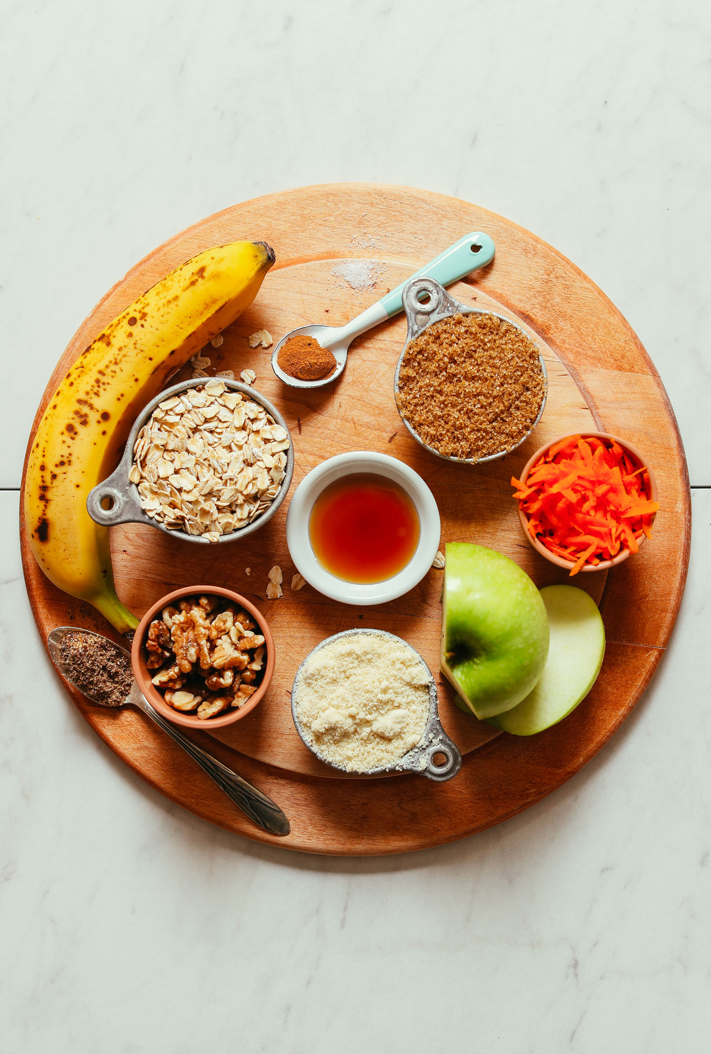 Wood cutting board with ingredients for making Carrot Apple Snack Cake