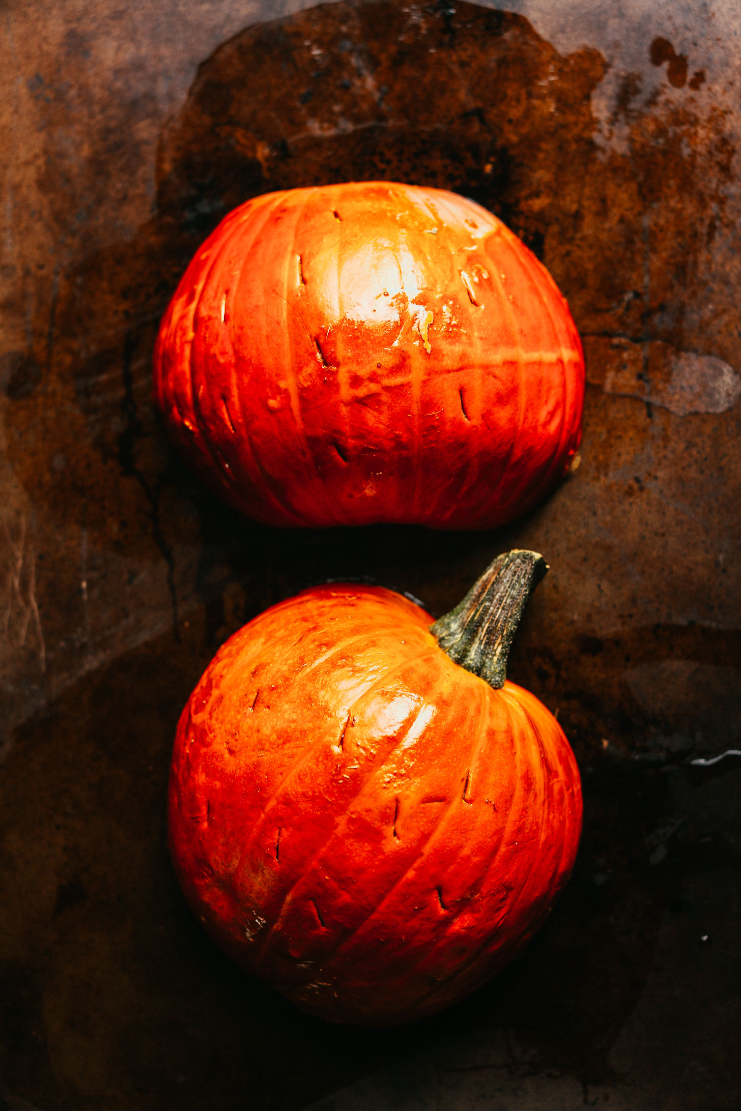 Freshly roasted pumpkin halves on a baking sheet