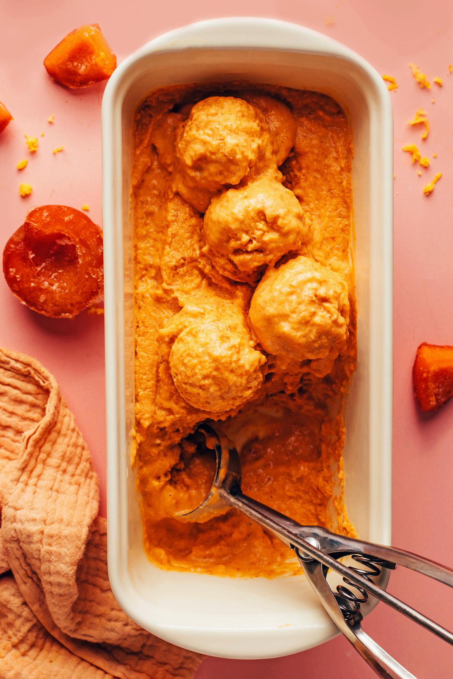 Loaf pan with scoops of apricot sorbet