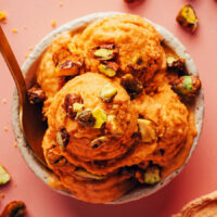 Overhead shot of scoops of vegan apricot sorbet topped with candied pistachios