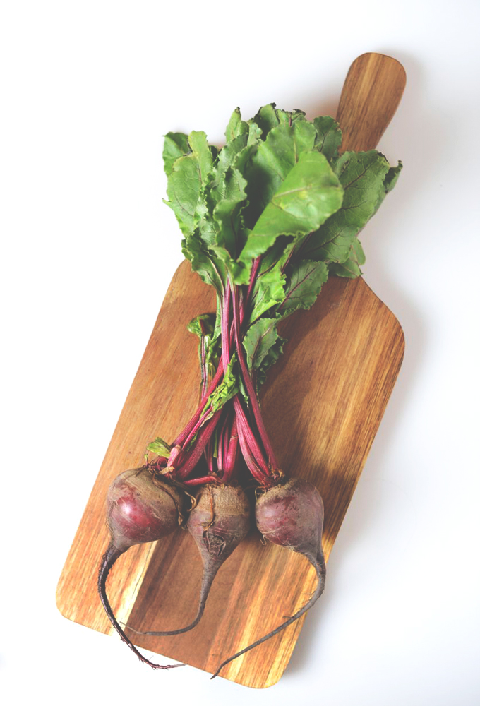 Cutting board of beets for making homemade beet juice