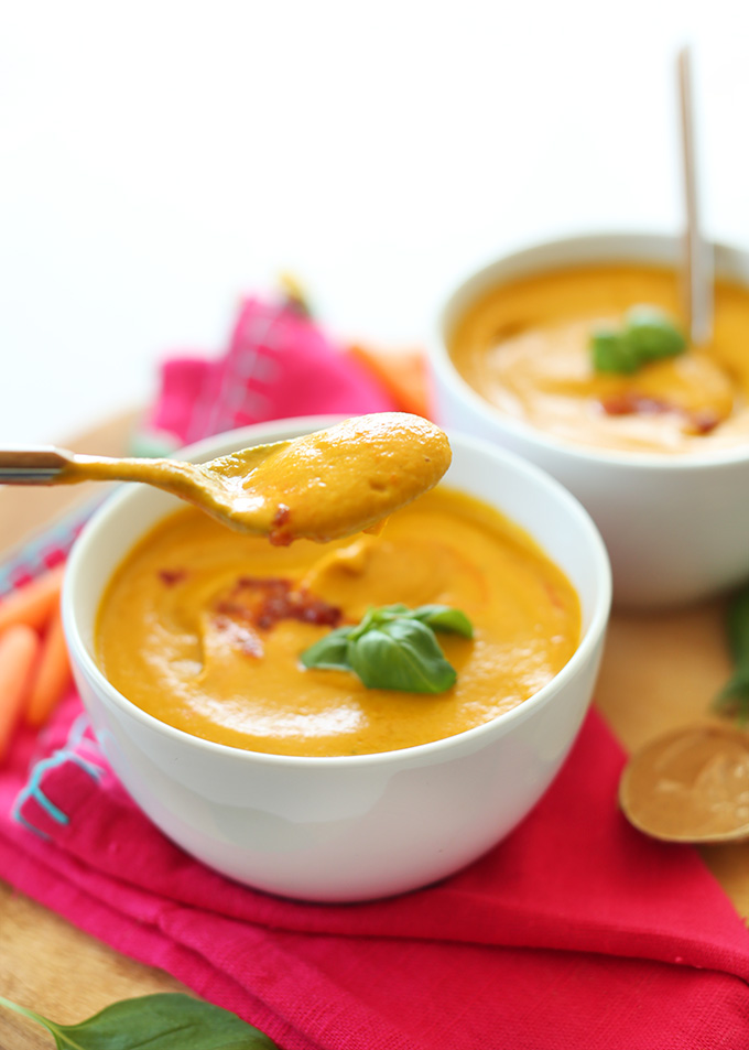 Picking up a spoonful of gluten-free vegan Creamy Carrot Soup made with peanut butter and basil