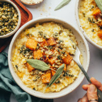 Holding a spoon in a bowl of Instant Pot butternut squash risotto