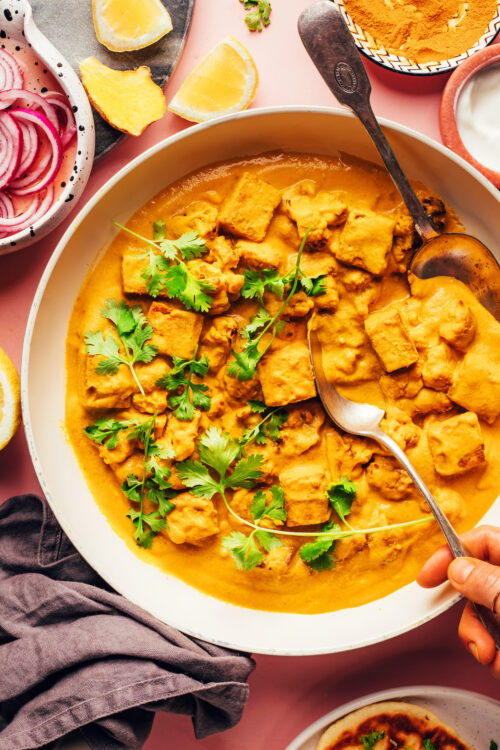 Overhead shot of a skillet of vegan tofu cauliflower korma curry