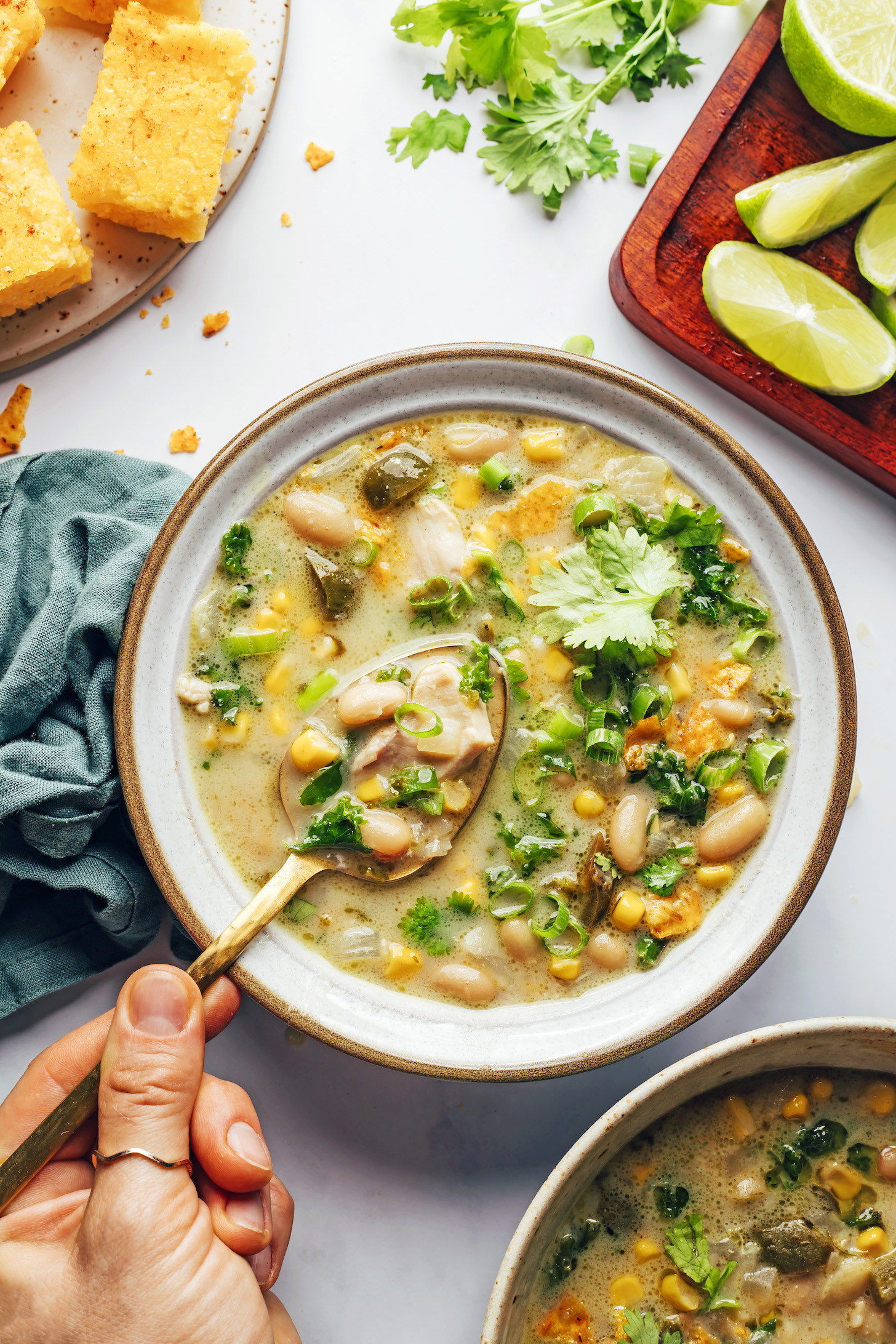 Gold spoon scooping up a bite of our dairy-free white bean chicken chili recipe