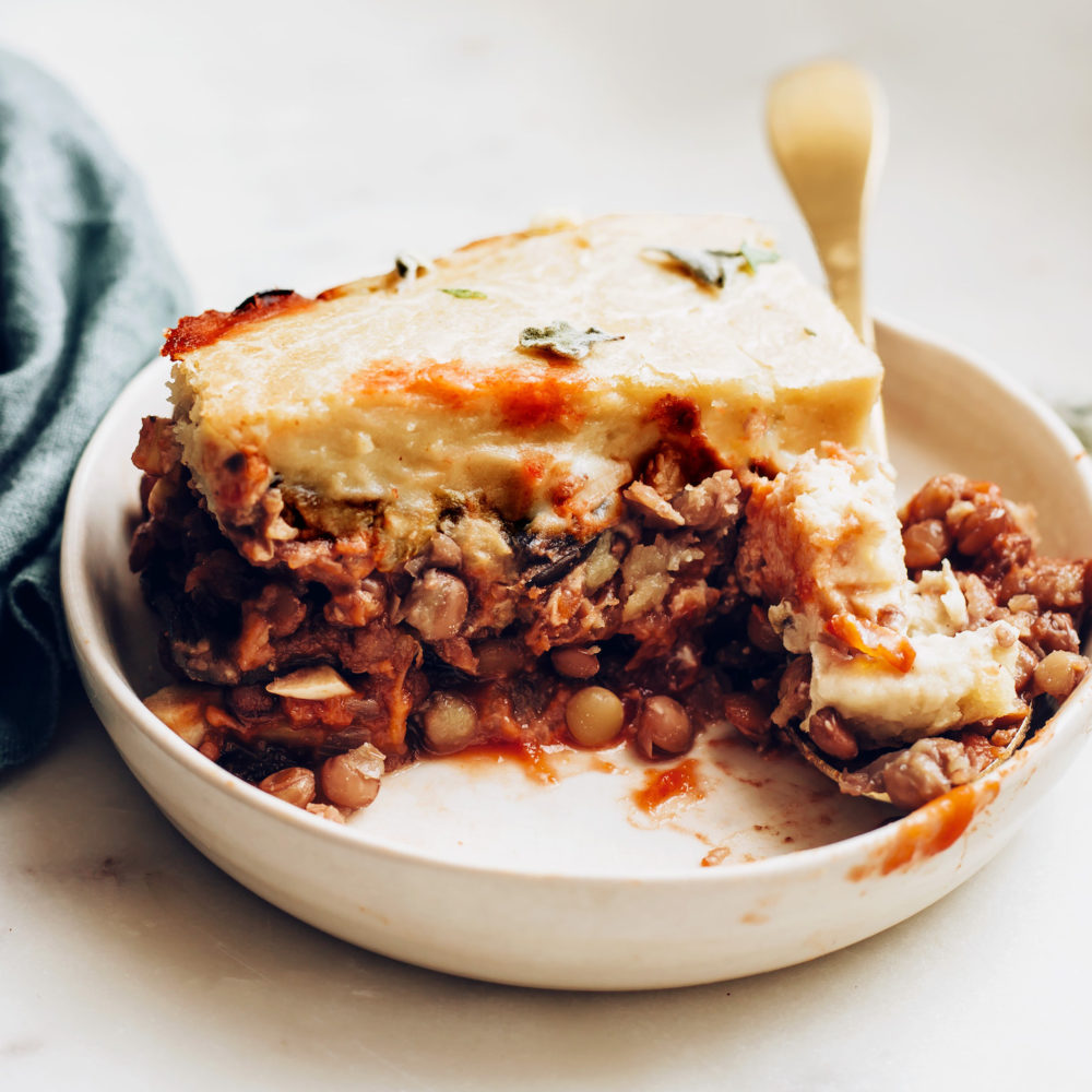 Fork resting on a plate of vegan moussaka