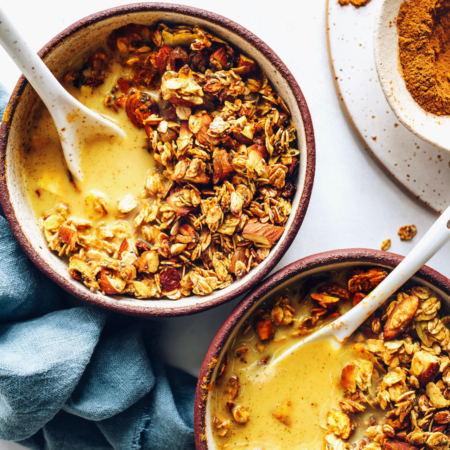 Bowls of golden milk granola with dairy-free milk