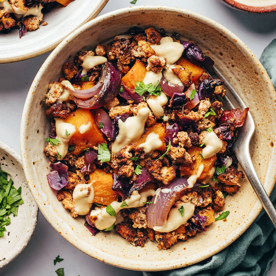 Tahini sauce drizzled over baked tofu and winter veggies