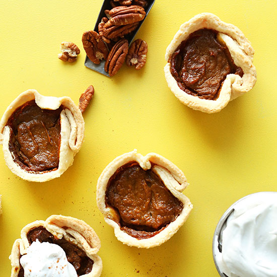 Mini Vegan Pumpkin Pies on a bright yellow background