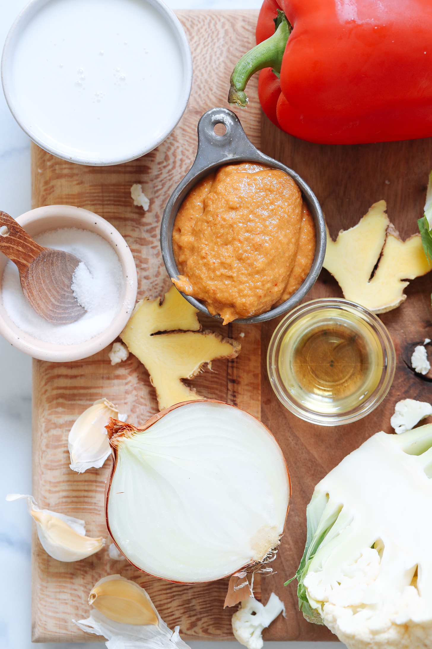 Coconut milk, red bell pepper, curry paste, ginger, oil, cauliflower, onion, and salt