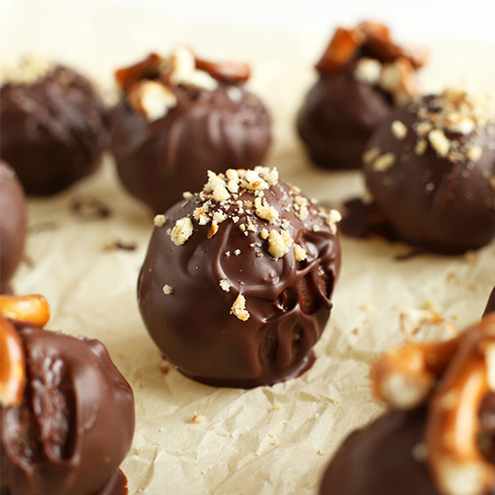 Parchment-lined baking sheet of Vegan Peanut Butter Pretzel Truffles