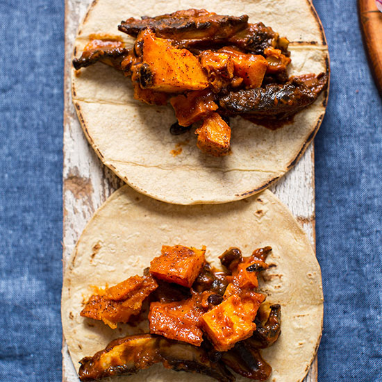 Two Portobello & Butternut Squash Tacos on a wood plank