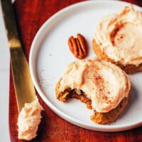 Frosted pumpkin oat cookies on a plate