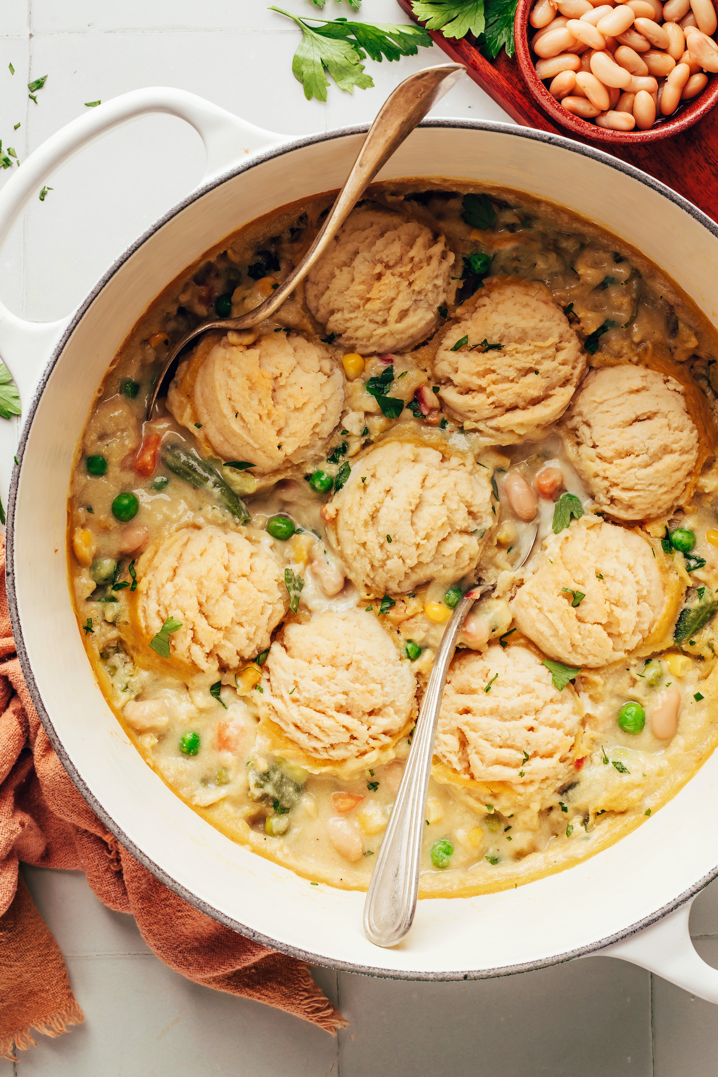 Spoons in a Dutch oven filled with our vegan pot pie soup recipe