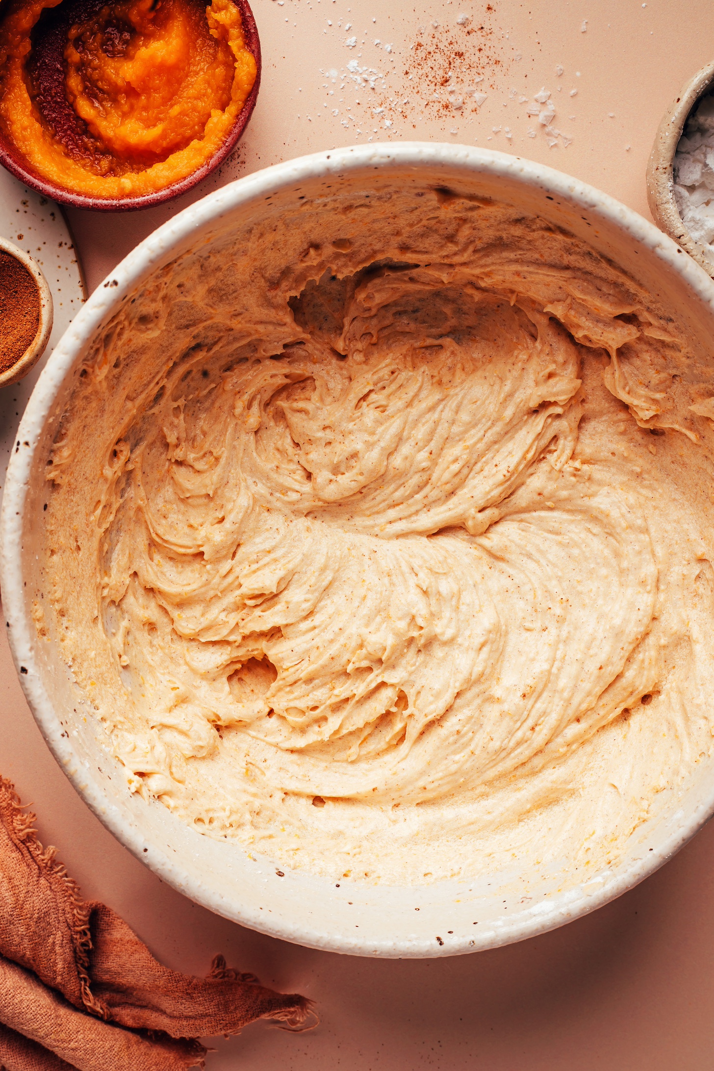 Bowl of light and fluffy vegan pumpkin buttercream frosting