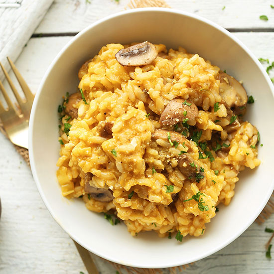 Bowl of Vegan Leek Mushroom Risotto topped with chopped parsley